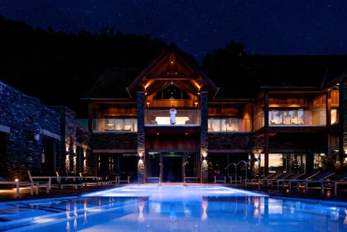 a large swimming pool in front of a building at night at Lodore Falls Hotel & Spa in Keswick