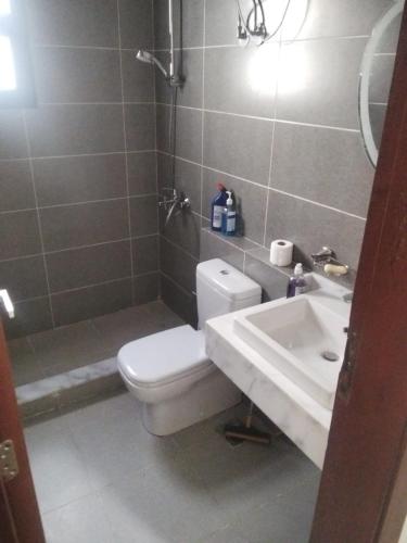 a bathroom with a toilet and a sink at Azha Townhouse in Ain Sokhna