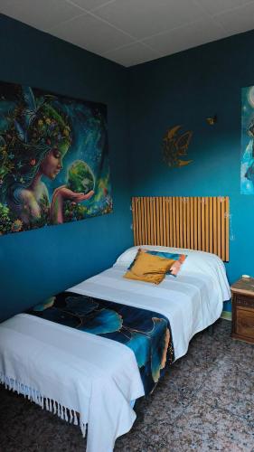 two beds in a room with a painting on the wall at lo flamenc @Amposta in Amposta