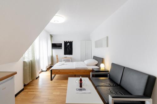 a living room with a bed and a couch at Boardinghaus Perani in Augsburg