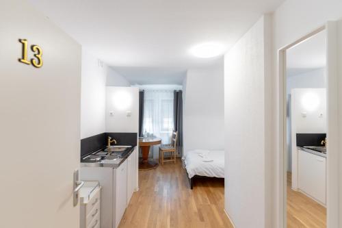 a kitchen with white cabinets and a counter top at Boardinghaus Perani in Augsburg