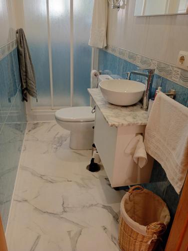 a bathroom with a sink and a toilet at Apartamento By Llu in Alcalá la Real