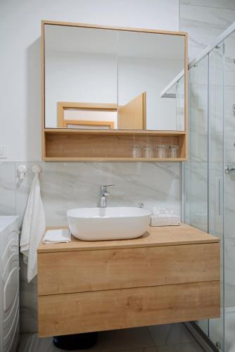 a bathroom with a sink and a mirror at Apartman Lami in Krapina