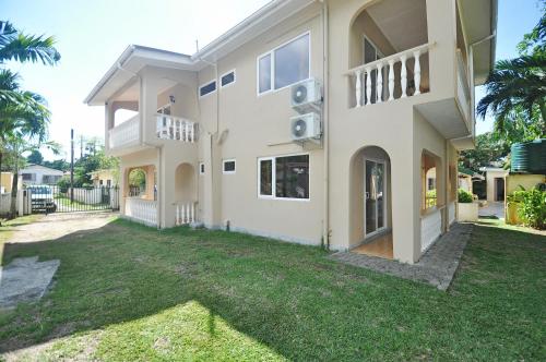 a large house with a yard in front of it at GT Self Catering Apartments in Beau Vallon