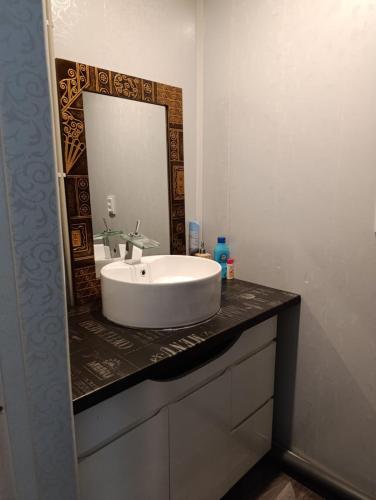 a bathroom with a white sink and a mirror at Rukiši in Saulkrasti