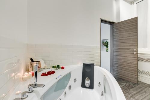 a bathroom with a bath tub with a sink at Relais Colonna in Rome