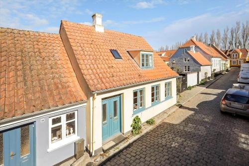 a row of houses with orange roofs on a street at AE330-Aeroskobing-Ostergade-8 in Ærøskøbing