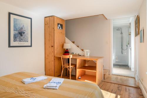 a bedroom with a bed and a desk and a table at La Cerisaie in Lyon