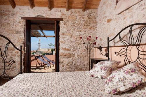 a bedroom with a bed and a stone wall at Canary House With Heated Pool in Tuineje