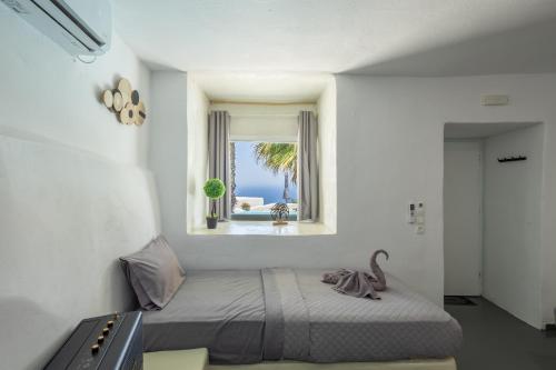 a bedroom with a bed with a view of the ocean at Loft Kaves Pool & Bar Suites in Pyrgos