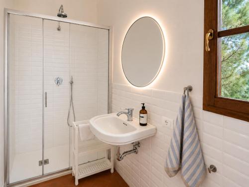 a white bathroom with a sink and a shower at Podere di Montecchio in Florence