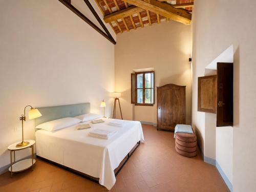 a bedroom with a large white bed in a room at Podere di Montecchio in Florence