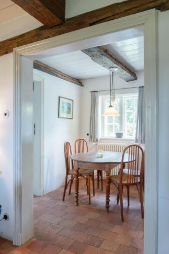 a dining room with a table and chairs at Ferienwohnung Blücherkate I - Boldevitzer Rügenkaten in Parchtitz