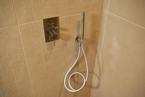 a shower head on a wall in a bathroom at Vivere Hotel in Catania
