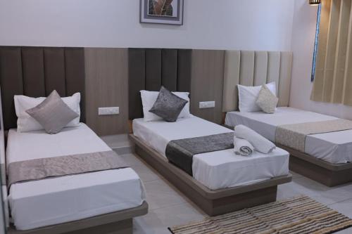 a hotel room with two beds in a room at Hotel vs rooms in Ankleshwar