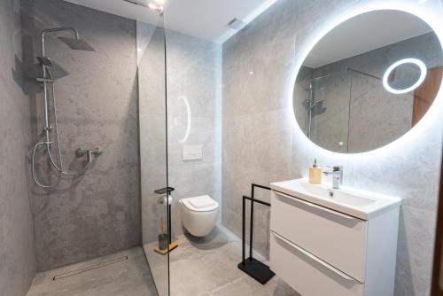 a bathroom with a toilet and a sink and a mirror at Bieszczady Hill - Dolna in Czarna