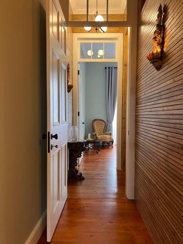 a hallway with a door leading to a living room at Hommage in Horta