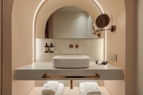 a bathroom with a sink and a mirror at Villa Coo Boutique Hotel - Adults Only in Kos