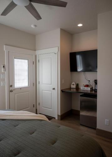 a bedroom with a bed and a flat screen tv at The Sand and Sage Suite in Page