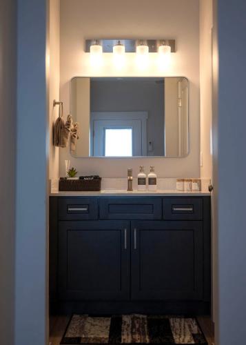 a bathroom with a sink and a mirror at The Sand and Sage Suite in Page