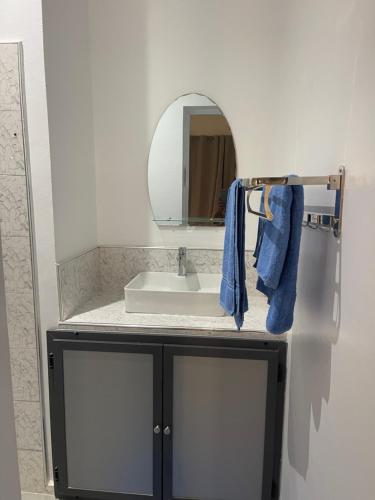 a bathroom with a sink and a mirror at Rubis2 appart C2 in Ngaparou
