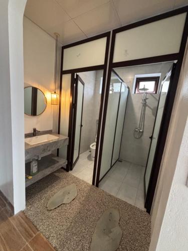 a bathroom with a shower and a sink at Lơ Mơ House in Làng Môn