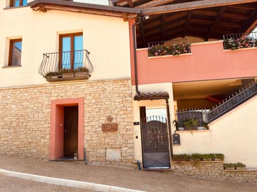 a building with flower boxes on the balconies at Bentu Boutique Apartment in San Nicolò Gerrei