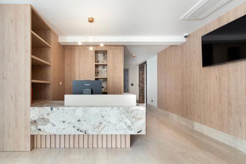 an office lobby with a marble counter and a tv at VELIERO Residence by Bracera in Lugovi