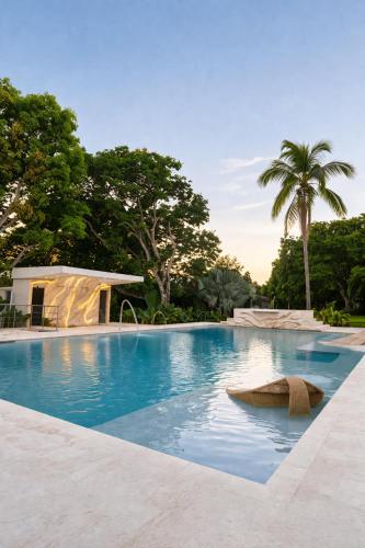 a large swimming pool with a palm tree at Finca Hotel Dubai in San Jerónimo
