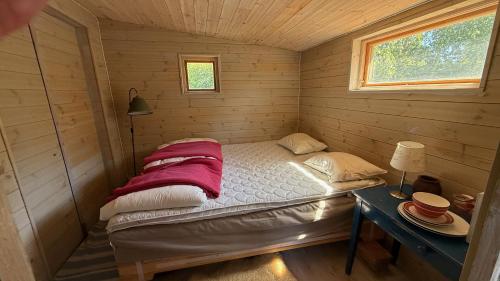 a small room with a bed in a wooden cabin at HavetÖsterlen -Sandpärlan 8 & Sandboxen 2 in Borrby