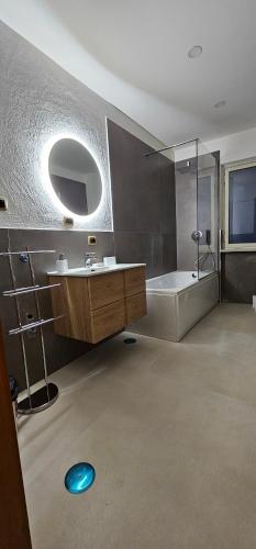 a bathroom with a tub and a sink and a shower at B&B Gianni in Capodrise