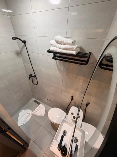a bathroom with a toilet and a sink and a mirror at Riad Villa Elizabeth in Nouaseur