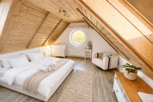 a bedroom with a large bed in a attic at Psí bouda Benecko in Benecko