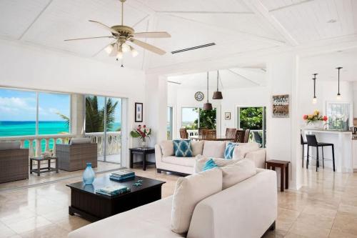 a living room with white furniture and the ocean at Villa with Sea View in Providenciales