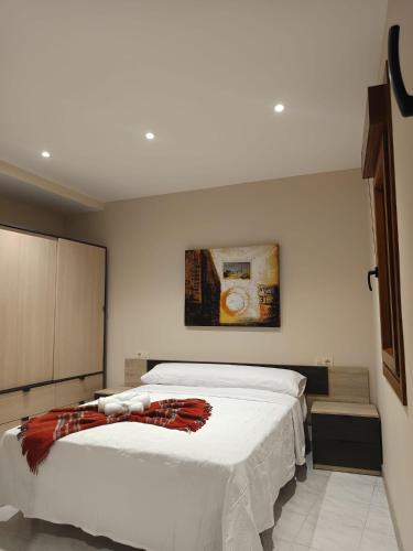 a bedroom with a bed and a painting on the wall at Casa Pampillon in Cangas de Morrazo