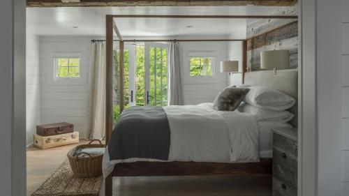 a bedroom with a large bed and a mirror at The Inn at GrayBarns in Norwalk