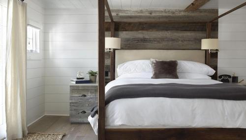 a bedroom with a large bed with white sheets at The Inn at GrayBarns in Norwalk