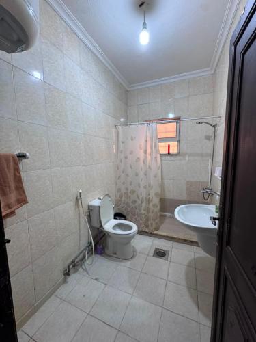 a bathroom with a toilet and a sink at شقه مفروشة الجبيهه in Amman