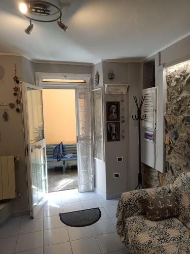 a living room with a couch and an open door at Casa Ida in Montemarcello