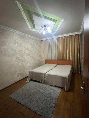 a bedroom with two beds and a skylight at flat in Itʼkhvisi