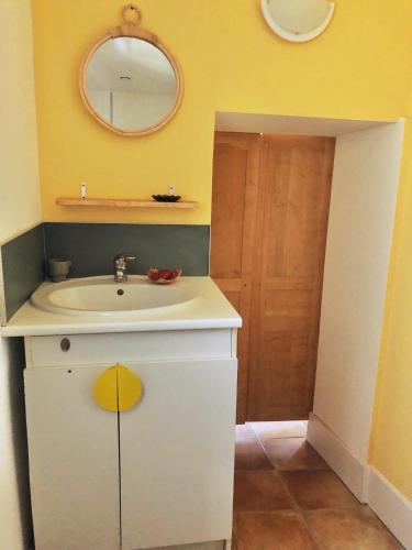 a bathroom with a white sink and a mirror at Espace Bulle-Zen in Burlats