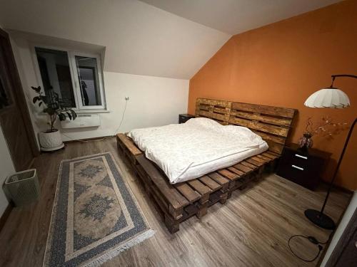 a bedroom with a bed on a wooden floor at Secret Garden in Dushanbe