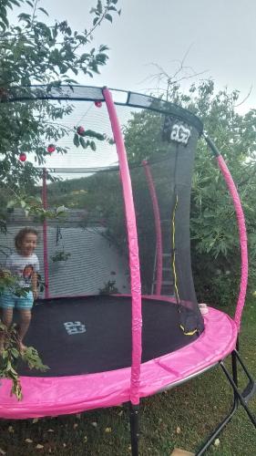 a little girl sitting on a trampoline at Casa Anna&Criss in Orşova