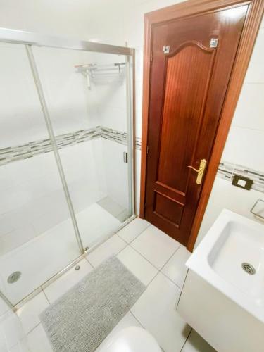 a bathroom with a shower and a sink at La Ola in El Médano