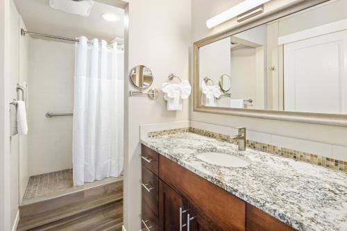 a bathroom with a sink and a mirror at Royal Kuhio Resort in Honolulu