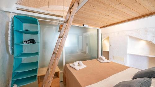 a room with a bunk bed and a ladder at Rentbeat collection 3 historic center in Ostuni