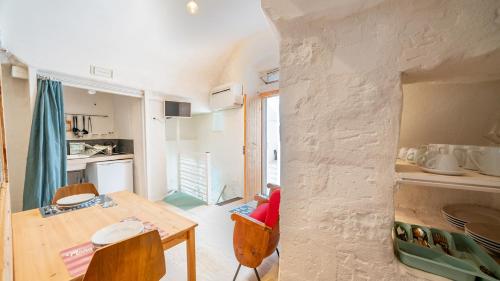 a kitchen and dining room with a table and chairs at Rentbeat collection 3 historic center in Ostuni