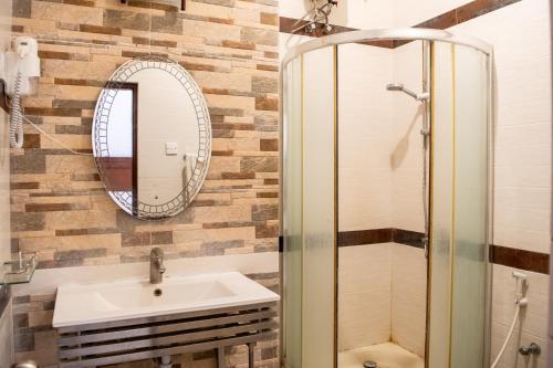 a bathroom with a sink and a mirror at Roy's Polonnaruwa in Polonnaruwa