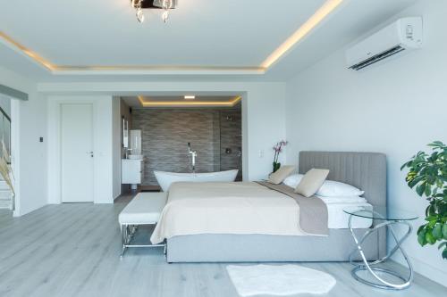 a bedroom with a large bed and a bath tub at Villa Rima in Vonyarcvashegy