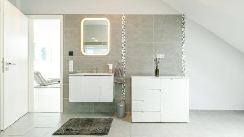 a bathroom with a sink and a mirror at Villa Rima in Vonyarcvashegy